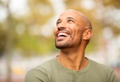 candid portrait of a happy, confident man smiling outdoors